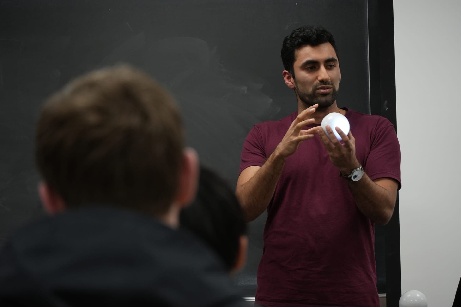 Sohum teaching quantum concepts with Qubi to high school students