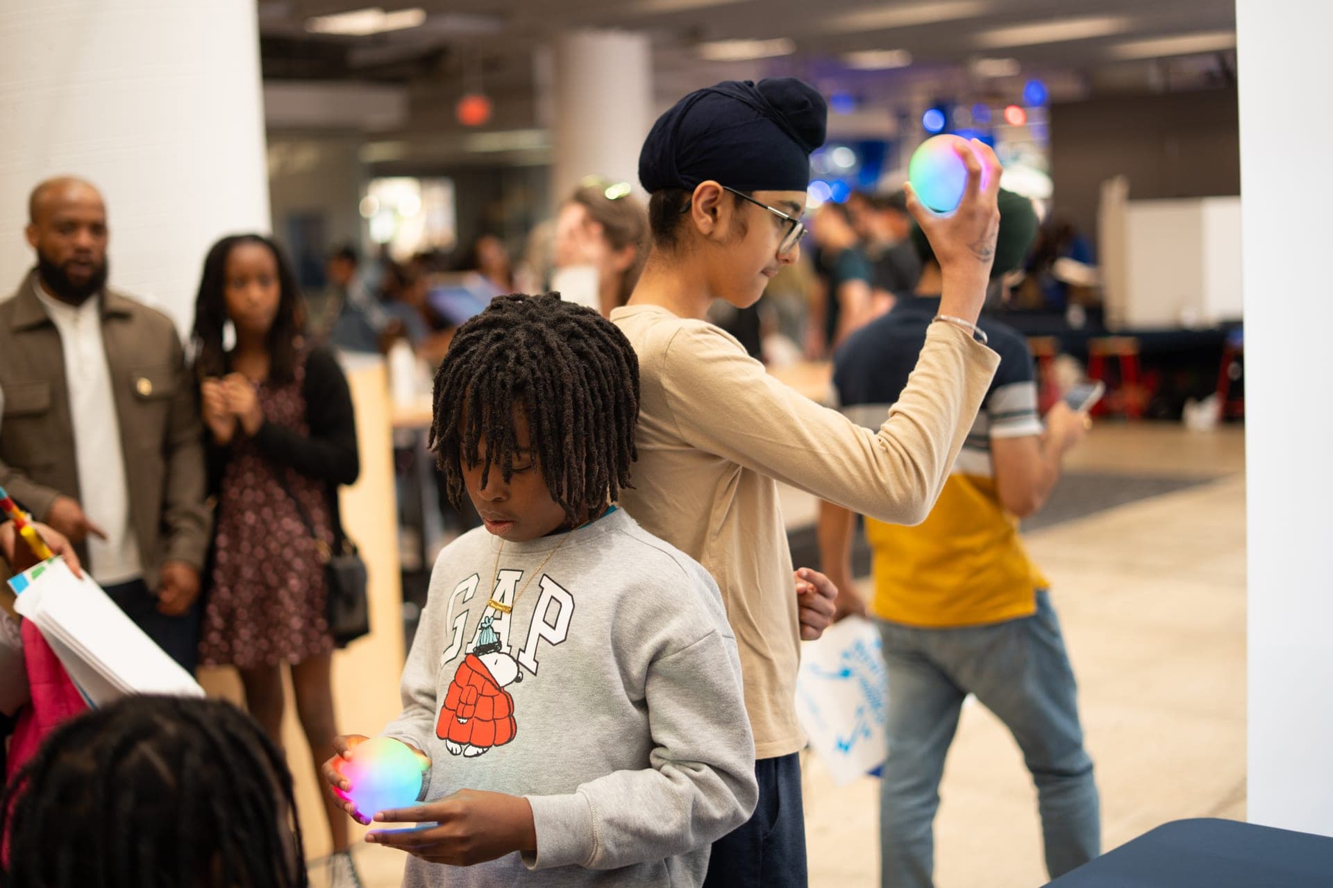 Two participants standing back-to-back with entangled Qubis